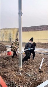 Four Workers Cooperating to Install Steel Column, Busy Construction Scene!