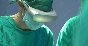 Close-up Shot Team of surgeons wearing augmented reality headsets to performing operation on a patient in operating theater at High tech hospital. Future healthcare and medical technology concept. Stock Video