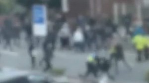 Football fans breakout in violent fight on streets of Manchester