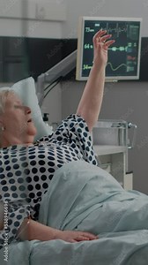 Vertical video: Old woman breathing heavily and asking for medical assistance while doctor and nurse helping with respiratory issues. Medical team using oxygen tube to cure hyperventilating patient Stock Video