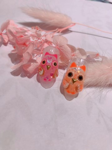 Creating nail art with cute owl motifs in pastel and neon colors