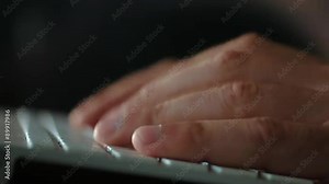 Men's fingers typing on a computer keyboard