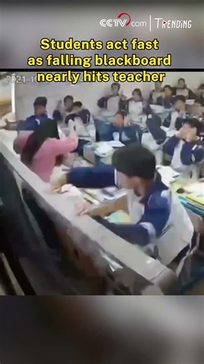 Students act fast as falling blackboard nearly hits teacher