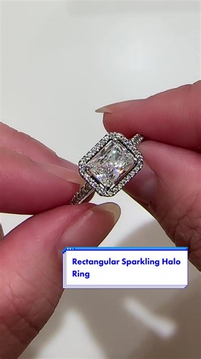 This stunning vintage-inspired ring is one you'll treasure forever. Crafted in sterling silver, this sophisticated Pandora Timeless ring is embellished with a halo of sparkling cubic zirconia stones and features a large rectangular radiant-cut stone as a stand-out centrepiece. Wear it on its own as a statement cocktail ring or style it with contrasting Pandora rings for a fresh, contemporary look. #Pandora #PandoraRing #PandoraJewellery #SolitaireRing #PromiseRing #EngagementRing #WeddingRing