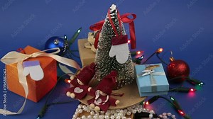 Christmas carousel with a Christmas tree and bright gifts. New Year's festive tree with gifts on the background of a bright garland.