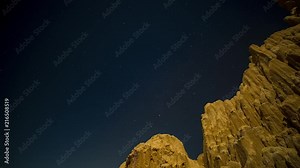 Long exposure, motion time lapse of the stars and moon over the clay rock formations of Cathedral Gorge State Park, Nevada