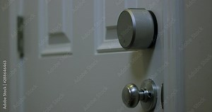 Smart home door lock automatically locks itself once door is closed - close up on door locking