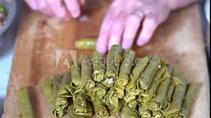 Making dolma, yaprak sarma, stuffed grape leaves, traditional turkish cuisine.