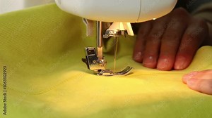 The process of sewing fabric on a sewing machine, The sewing machine needle in motion