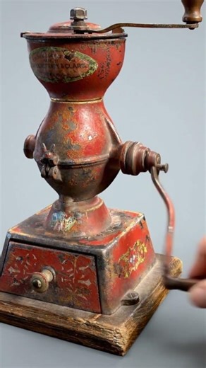 An antique Landers, Frary & Clark cast-iron coffee grinder, often referred to as a "coffee mill"