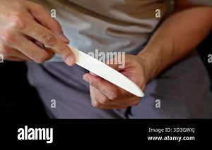 Man filing fingernails with nail file. Personal grooming and hand care hygiene concept Stock Video Footage - Alamy