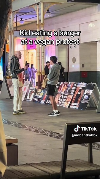 Kid Eating Burger at Vegan Protest