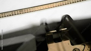 Typing the expression Trending Today with an old manual typewriter