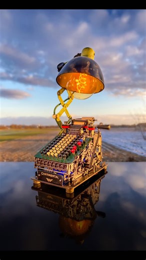 Jürgen Klöck on Instagram: "Witness the fusion of a century-old mechanical marvel and modern artistic vision. This Continental 8 adding machine, a masterpiece of 1920s engineering, has been reimagined and breathed into new life. Through the art of assemblage, I’ve transformed its intricate gears and levers into a functional, retrofuturistic sculpture. The warm glow of the vintage filament bulb highlights the tactile beauty of analog history in our digital age. From calculating figures to illum