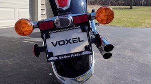 Native Pride Motorcycle License Plate Frame – Matte Black with White Lettering & Feather Icons, 4 Screws Included by Voxel Creations