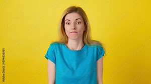Confusion, shame and young woman spreading hands say oops ouch oh omg i am so sorry. Shy female lady, uncertain emotion with doubt problem, hand gesture with mockup in studio on yellow background
