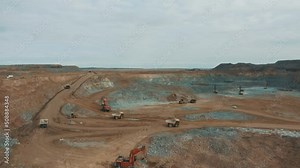 This stock video shows the work of specialized equipment at an open-pit gold mine. This video will decorate your projects related to the gold mining industry, mining.