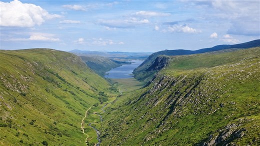 A long valley between green mountains