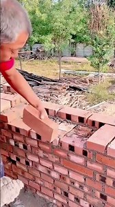 The man is laying bricks to build a strong wall structure