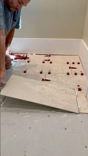 Tile floor install with perfect level master leveling clips.