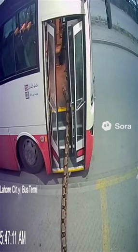CCTV angle from Lahore City Bus Terminal, “05:47:08 AM.” A long python slides up the steps of an empty bus. The door closes automatically behind it. For 12 seconds, the camera pixelates and shows mild distortion. Bus departs — driver unseen. | Qaisar Roonjha