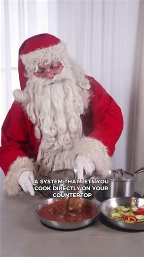 Santa Claus cooking directly on the kitchen island — with no visible cooktops.