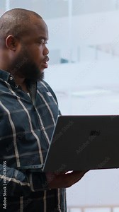 Vertical Video Business management team planning an office relocation and seeing new high class space tour with the broker, analyzing blueprints. Reaching a legal agreement with leasing contract