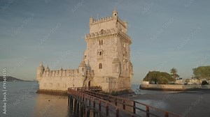 The Torre de Belem (Belem Tower) during sunrise is one of the symbols of the golden era of the Portuguese, Lisbon, Portugal