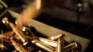 5.56x45mm Bullets drop in to a box of ammunition. 4k Slow Motion