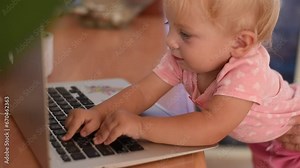 Little happy baby smile and typing on keyboard of laptop. Small hand fingers touch black buttons. Baby learning new world. play on laptop. Stock Video