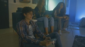 Three friends playing video games at night - Free Stock Video