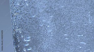 Air bubbles rise from the top of the water. Carbonated water