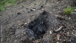 Gunpowder igniting and burning down. exlposives detonating on the ground. sulfur exhalation and explosion