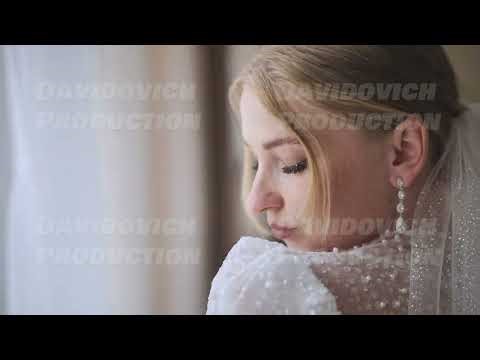The bride with a bouquet at the window.