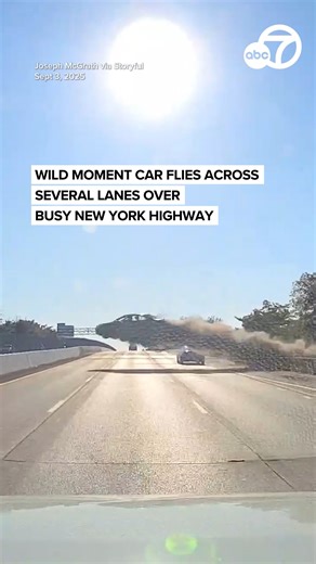 A driver's dashcam captured the wild moment a vehicle went flying over several lanes of traffic on the Sunrise Highway, one of the busiest freeways on Long Island. According to local reports, a 70-year-old man sped across a grassy embankment and launched off a hill, soaring over the highway. The vehicle cleared multiple lanes of westbound traffic before slamming down on the eastbound side of the highway and sliding into a tree. The driver sustained minor injuries in the crash, but no other vehic