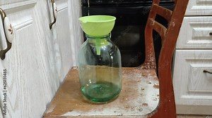 Homemade moonshine. Cooking moonshine in the kitchen. Process of distillation