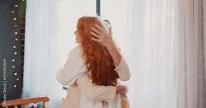 two young women hug tightly and emotionally when they meet in a restaurant. strong hugs of two women from the joy of a long-awaited meeting Stock Video