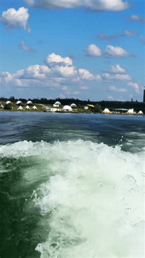 clip-4008336539-foamy-trail-sailing-motorboat-on-azure-water
