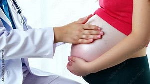 Doctor palpating the girl's belly with hands and applying consistent pressure