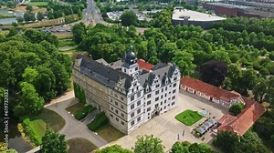 Drone shot of Wolfsburg Castle ( Schloss Wolfsburg ) . The Wolfsburg is a medieval lowland and water castle in North Germany .
