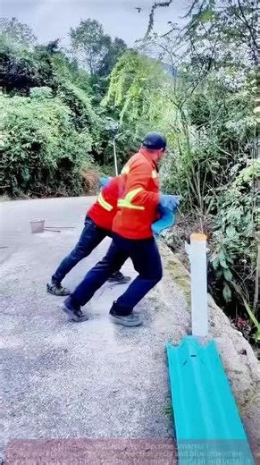 Roadside Guardrail Repair: Workers Lift the Barrier Together