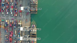 Aerial view. Container ship in pier with crane bridge carries out export and import business in the open sea. Logistics and transportation