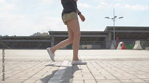 Woman legs jogging on the street, super slow motion