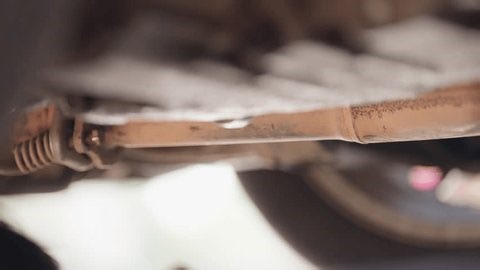 clip-4030627817-close-up-mechanic-using-tool-inspect-repair-under