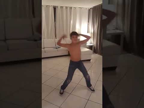 Shirtless boy in jeans dancing to timber