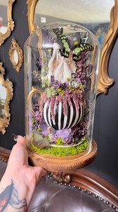 This is a mashup and idk what to call it? Beetalice? Alicejuice? Alice in Beetlejuice? Beetlejuice in Wonderland? Anyways - This will be coming with me to the @odditiesandcuriositiesexpo in Las Vegas next month! Real preserved rabbit ears, green hair steak butterfly, electric green swallowtail, green chafer beetles, drink me vial, amethyst cluster and points, pocketwatch, and dried florals on a teacup set made by @livelyghosts I’m so excited to finally use! | Bewitched Oddities