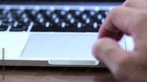 Man hand typing on keyboard and touching or pinch on track pad of computer notebook