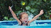 Girl in the pool. Girl has fun in the inflatable pool set in the...