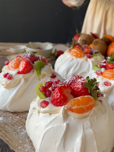 Pavlova *Pavlova:* *Meringue:* - 6 egg whites - 1 cup granulated sugar - 1 cup powdered sugar - 3 teaspoons cornstarch - 1 teaspoon vinegar *Instructions:* 1. Begin whipping the egg whites with a mixer on low speed. Gradually add the sugar, vinegar, and cornstarch while continuing to whip. Keep whipping until the sugar is completely dissolved, and the mixture becomes glossy and firm. The meringue should not drip when the mixer is lifted! 2. Place the mixture on a baking tray lined with parchment