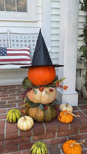 Christina Clericuzio on Instagram: "DIY Pumpkin witch!🧙‍♀️🎃 A fun way to dress up your Fall front porch decor! Stack three pumpkins and dress them up with some garland and a witches hat!I find that fantasy pumpkins are the easiest to stack! Should I carve a face into the top pumpkin??🤔 #fallfrontporch #pumpkindecor #pumpkinwitch #witchdecor #frontporchdecor #falldecorations #easydecor #fallideas"